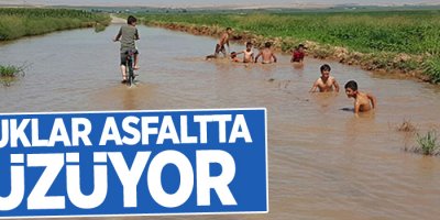 Çocuklar asfaltta yüzüyor